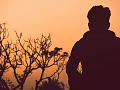 man standing alone outside at sunset
